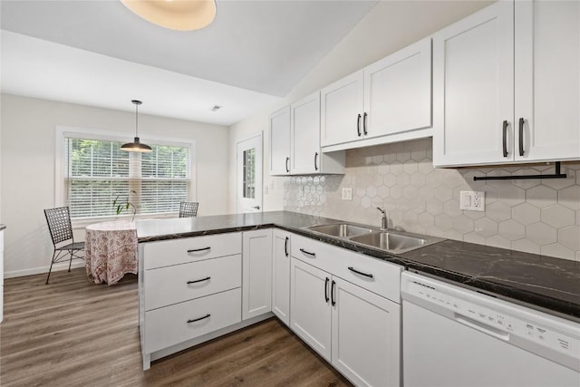 3921 Lexington Dr NE Unit C, Cedar Rapids, IA 52402 - kitchen featuring white dishwasher, dark wood-type flooring, white cabinets, tasteful backsplash, and vaulted ceiling