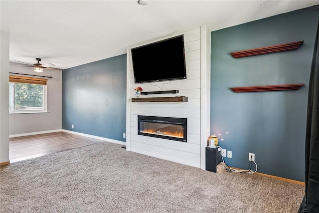 5929 Underwood Ave SW, Cedar Rapids, IA 52404 - unfurnished living room featuring carpet, a large fireplace, and ceiling fan