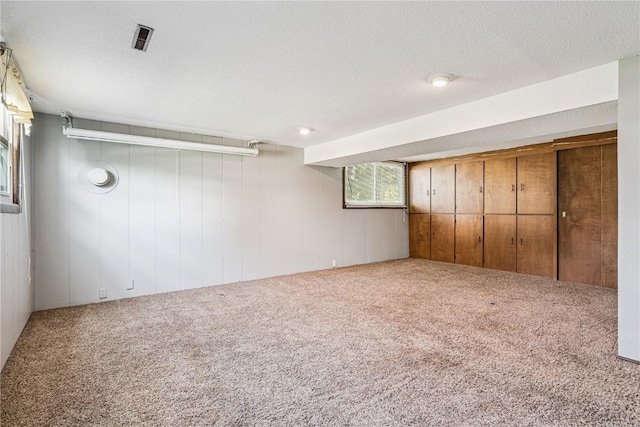 5929 Underwood Ave SW, Cedar Rapids, IA 52404 - unfurnished bedroom featuring carpet, wood walls, and a textured ceiling