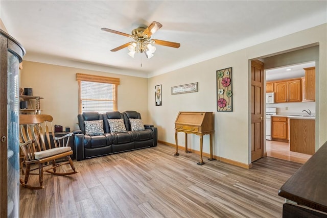 1039 31st St NE, Cedar Rapids, IA 52402 - living area featuring light wood-type flooring and ceiling fan