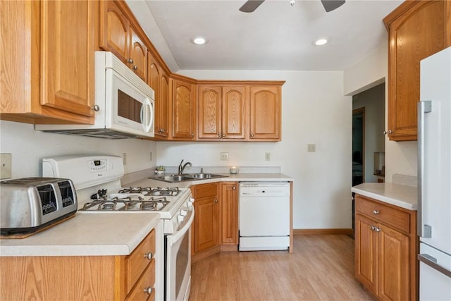 1039 31st St NE, Cedar Rapids, IA 52402 - kitchen with white appliances, light wood-style floors, ceiling fan, light countertops, and recessed lighting