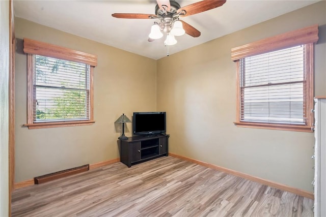 1039 31st St NE, Cedar Rapids, IA 52402 - unfurnished room featuring light wood-type flooring, a ceiling fan, and baseboard heating