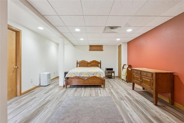 1039 31st St NE, Cedar Rapids, IA 52402 - bedroom featuring light wood-type flooring, a paneled ceiling, and recessed lighting