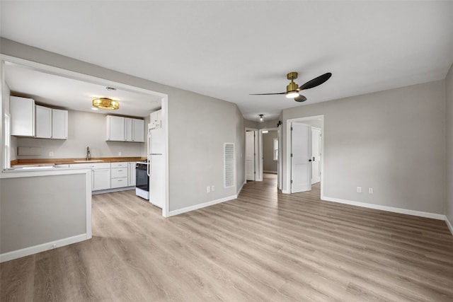 6404 Parkview Ave, Cedar Rapids, IA 52403 - unfurnished living room featuring light wood-type flooring and ceiling fan
