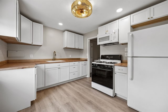 6404 Parkview Ave, Cedar Rapids, IA 52403 - kitchen featuring white appliances, butcher block countertops, light wood-style floors, white cabinets, and recessed lighting