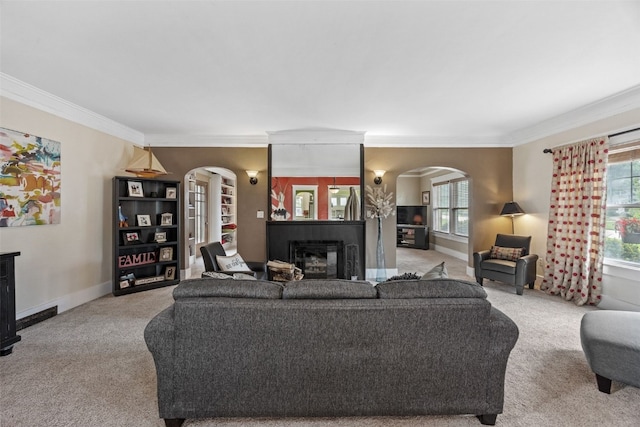 2144 Grande Ave SE, Cedar Rapids, IA 52403 - living room with arched walkways, a fireplace, carpet, and crown molding