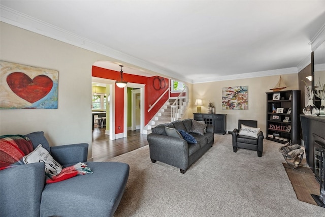 2144 Grande Ave SE, Cedar Rapids, IA 52403 - living area featuring arched walkways, crown molding, stairway, wood finished floors, and a fireplace