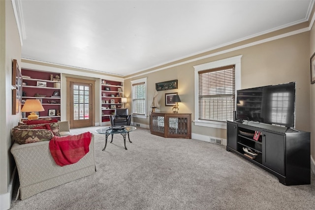 2144 Grande Ave SE, Cedar Rapids, IA 52403 - living room featuring ornamental molding, carpet flooring, and built in shelves