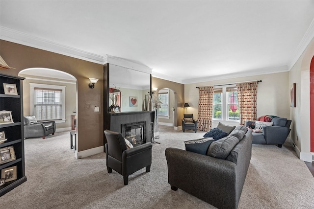 2144 Grande Ave SE, Cedar Rapids, IA 52403 - living room with arched walkways, ornamental molding, carpet floors, and a glass covered fireplace