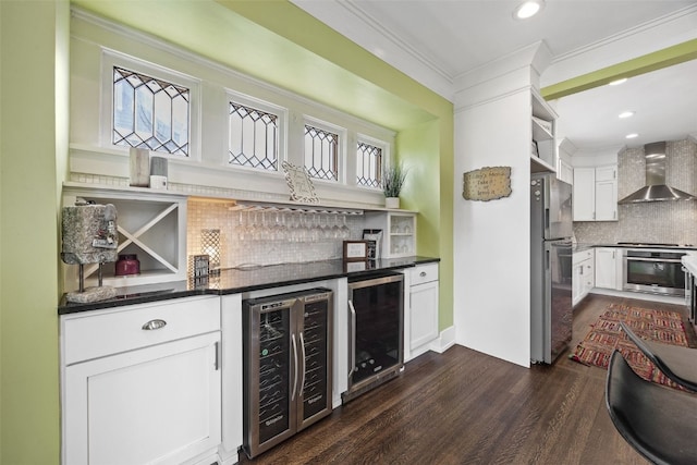 2144 Grande Ave SE, Cedar Rapids, IA 52403 - indoor dry bar with beverage cooler, wall chimney exhaust hood, stainless steel appliances, tasteful backsplash, and crown molding