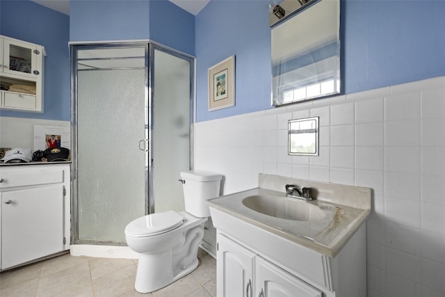 2144 Grande Ave SE, Cedar Rapids, IA 52403 - bathroom with tile walls, vanity, a shower stall, and tile patterned floors