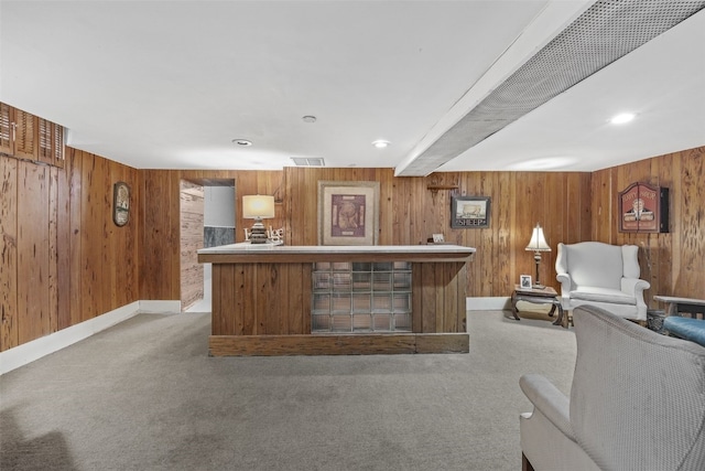 2144 Grande Ave SE, Cedar Rapids, IA 52403 - kitchen featuring wood walls, light colored carpet, and brown cabinets