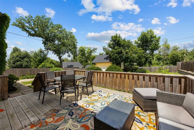 2144 Grande Ave SE, Cedar Rapids, IA 52403 - wooden deck featuring outdoor dining area and a fenced backyard