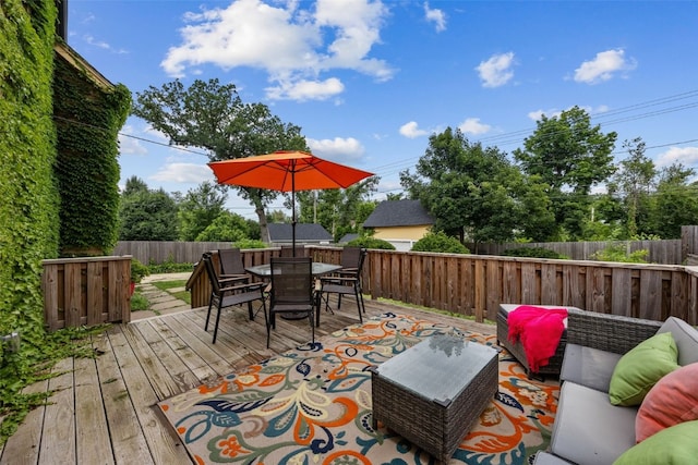 2144 Grande Ave SE, Cedar Rapids, IA 52403 - wooden deck featuring outdoor lounge area, a fenced backyard, and outdoor dining space