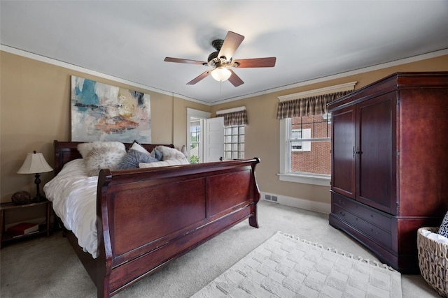 2144 Grande Ave SE, Cedar Rapids, IA 52403 - bedroom with light colored carpet, ornamental molding, and ceiling fan