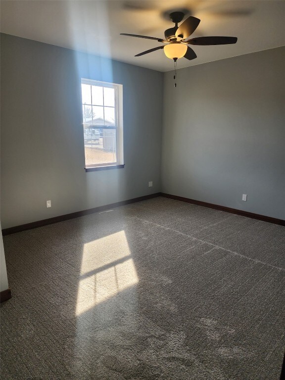 203 William Way, Newhall, IA 52315 - spare room featuring a ceiling fan and carpet