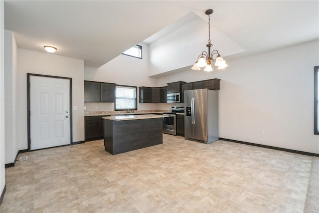 914 Deer Run Dr NE, Cedar Rapids, IA 52402 - kitchen featuring appliances with stainless steel finishes, a chandelier, light countertops, a center island, and pendant lighting