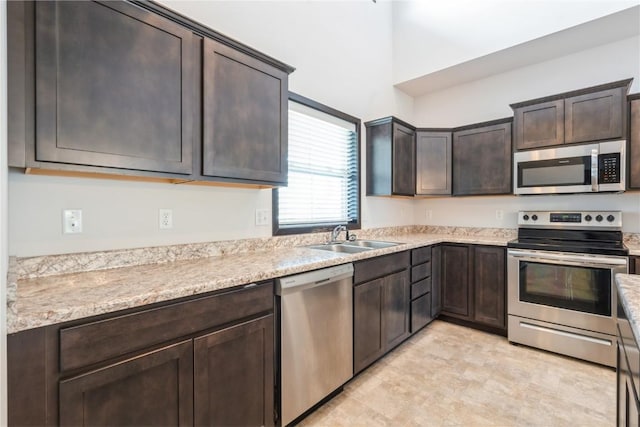 914 Deer Run Dr NE, Cedar Rapids, IA 52402 - kitchen with stainless steel appliances and dark brown cabinetry