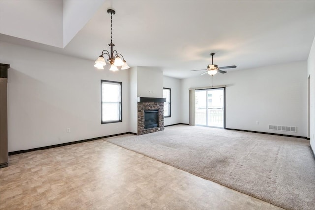 914 Deer Run Dr NE, Cedar Rapids, IA 52402 - unfurnished living room with carpet flooring, ceiling fan, a fireplace, and a chandelier