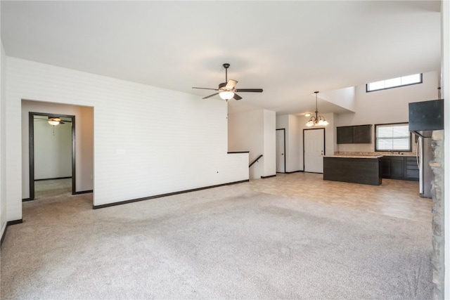 914 Deer Run Dr NE, Cedar Rapids, IA 52402 - unfurnished living room featuring a ceiling fan, light colored carpet, and a chandelier