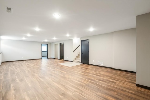 914 Deer Run Dr NE, Cedar Rapids, IA 52402 - unfurnished room with recessed lighting, light wood-style floors, and stairway