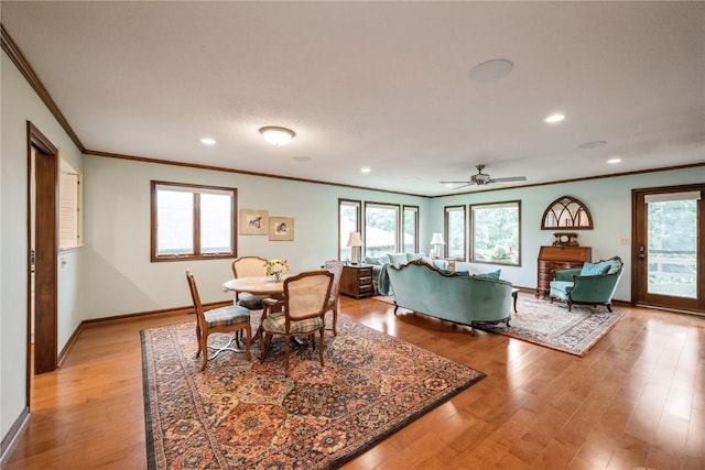 1579 Matterhorn Dr NE, Cedar Rapids, IA 52402 - dining space featuring ornamental molding, recessed lighting, light wood-style flooring, plenty of natural light, and ceiling fan