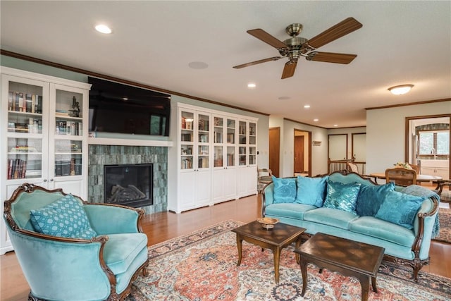 1579 Matterhorn Dr NE, Cedar Rapids, IA 52402 - living area featuring crown molding, ceiling fan, wood finished floors, recessed lighting, and a fireplace
