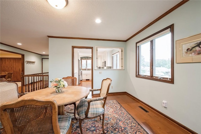 1579 Matterhorn Dr NE, Cedar Rapids, IA 52402 - dining room with wood finished floors, plenty of natural light, crown molding, and recessed lighting