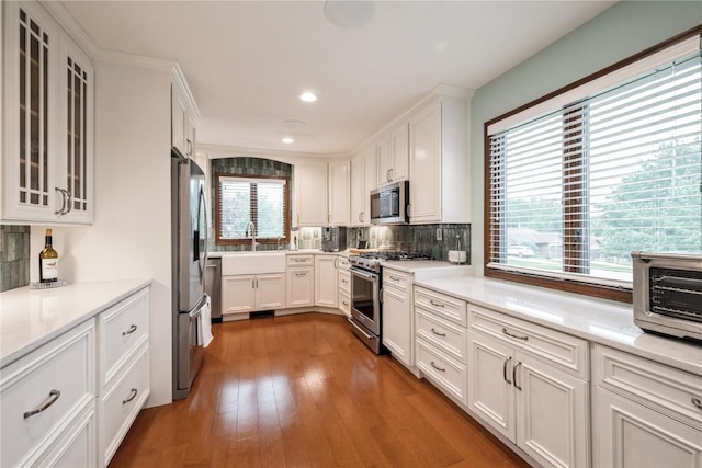 1579 Matterhorn Dr NE, Cedar Rapids, IA 52402 - kitchen with appliances with stainless steel finishes, white cabinets, tasteful backsplash, light countertops, and recessed lighting