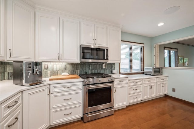 1579 Matterhorn Dr NE, Cedar Rapids, IA 52402 - kitchen featuring stainless steel appliances, white cabinets, light countertops, backsplash, and recessed lighting