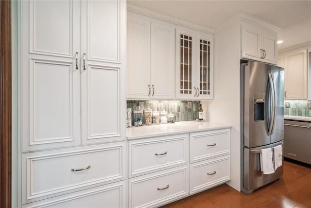 1579 Matterhorn Dr NE, Cedar Rapids, IA 52402 - kitchen with stainless steel appliances, tasteful backsplash, white cabinets, light countertops, and glass insert cabinets