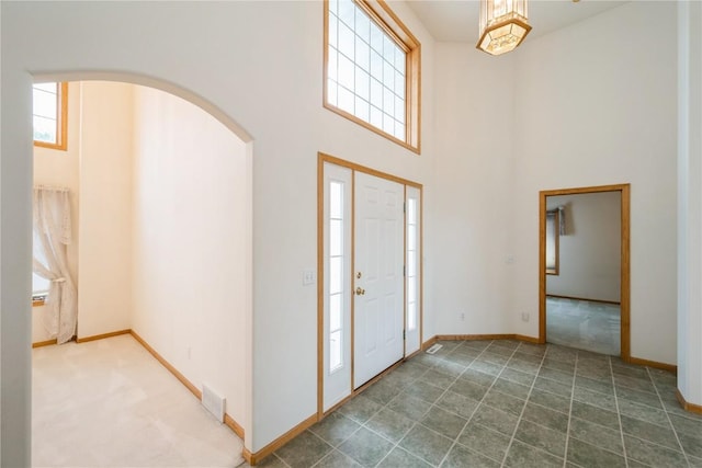 2500 Creekside Dr, Hiawatha, IA 52233 - entrance foyer with a towering ceiling, arched walkways, and carpet floors