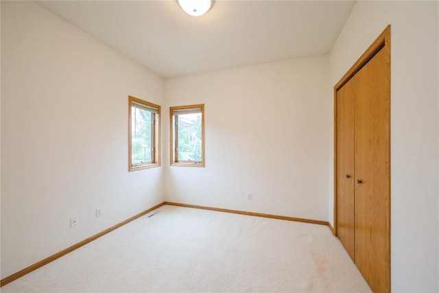 2500 Creekside Dr, Hiawatha, IA 52233 - unfurnished bedroom featuring light carpet and a closet