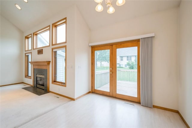 2500 Creekside Dr, Hiawatha, IA 52233 - unfurnished living room featuring plenty of natural light, french doors, a fireplace with flush hearth, a chandelier, and high vaulted ceiling
