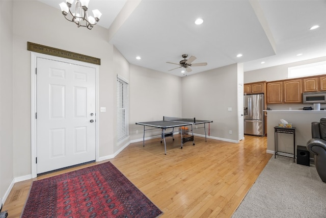 2515 Woodhill Dr SW, Cedar Rapids, IA 52404 - entrance foyer with recessed lighting, light wood-type flooring, a ceiling fan, and a chandelier