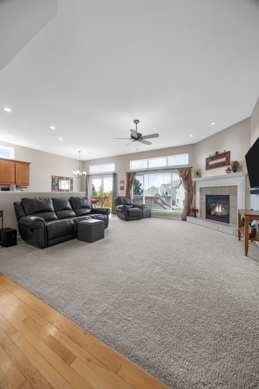 2515 Woodhill Dr SW, Cedar Rapids, IA 52404 - living area with a fireplace, recessed lighting, a chandelier, ceiling fan, and wood finished floors