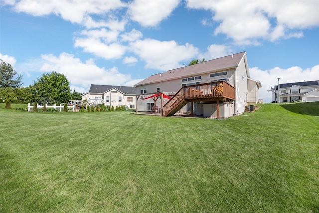 2515 Woodhill Dr SW, Cedar Rapids, IA 52404 - rear view of house with a wooden deck, stairs, and a lawn