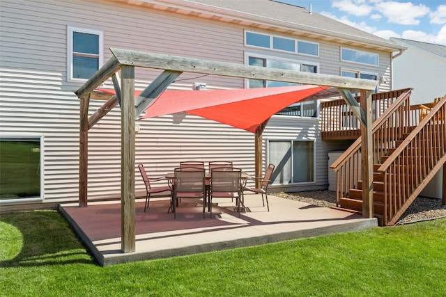 2515 Woodhill Dr SW, Cedar Rapids, IA 52404 - back of property with a wooden deck, stairway, and a patio area