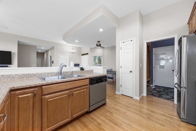 2515 Woodhill Dr SW, Cedar Rapids, IA 52404 - kitchen featuring stainless steel appliances, light wood-type flooring, brown cabinetry, ceiling fan, and recessed lighting
