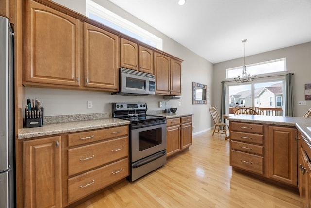 2515 Woodhill Dr SW, Cedar Rapids, IA 52404 - kitchen featuring stainless steel appliances, light wood-style flooring, brown cabinets, and light countertops