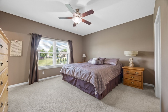 2515 Woodhill Dr SW, Cedar Rapids, IA 52404 - bedroom featuring light colored carpet and a ceiling fan
