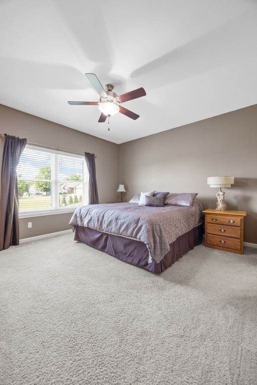 2515 Woodhill Dr SW, Cedar Rapids, IA 52404 - carpeted bedroom featuring baseboards and a ceiling fan