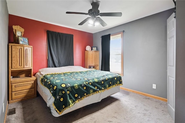 1009 W 1st St, Vinton, IA 52349 - carpeted bedroom with baseboards and ceiling fan