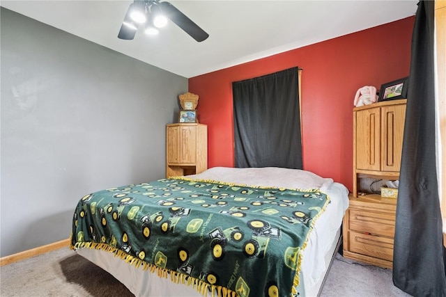 1009 W 1st St, Vinton, IA 52349 - carpeted bedroom featuring ceiling fan and baseboards