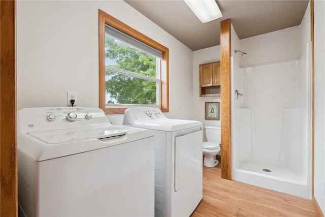 1009 W 1st St, Vinton, IA 52349 - laundry room with washing machine and clothes dryer and light wood-style flooring