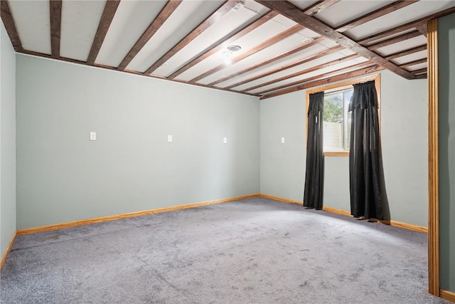 1009 W 1st St, Vinton, IA 52349 - carpeted empty room featuring baseboards