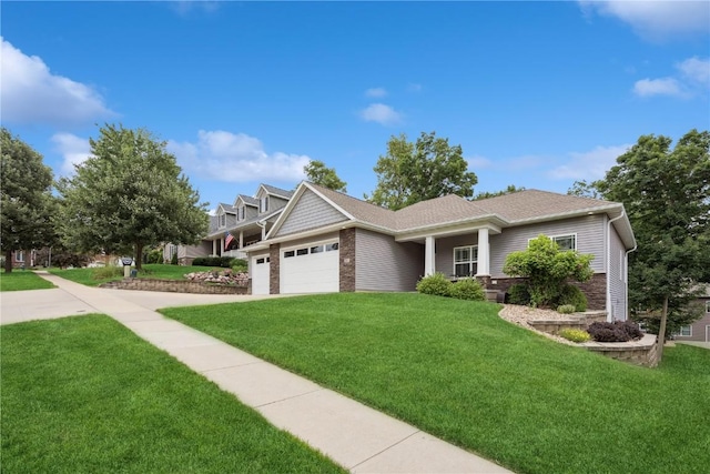 2021 Andrew Charles Dr NW, Cedar Rapids, IA 52405 - view of front facade with brick siding, a garage, and a front lawn
