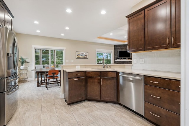 2021 Andrew Charles Dr NW, Cedar Rapids, IA 52405 - kitchen featuring stainless steel appliances, light countertops, a peninsula, recessed lighting, and dark brown cabinetry
