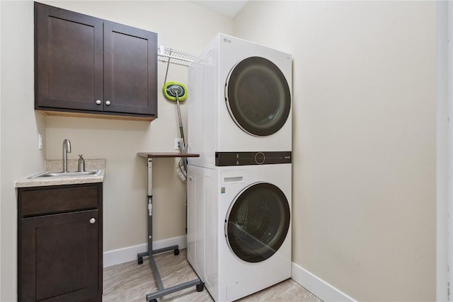 2021 Andrew Charles Dr NW, Cedar Rapids, IA 52405 - washroom with stacked washer / dryer, cabinet space, and wet bar