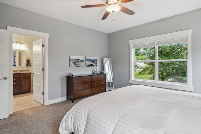 2021 Andrew Charles Dr NW, Cedar Rapids, IA 52405 - bedroom with light colored carpet, ensuite bath, and ceiling fan